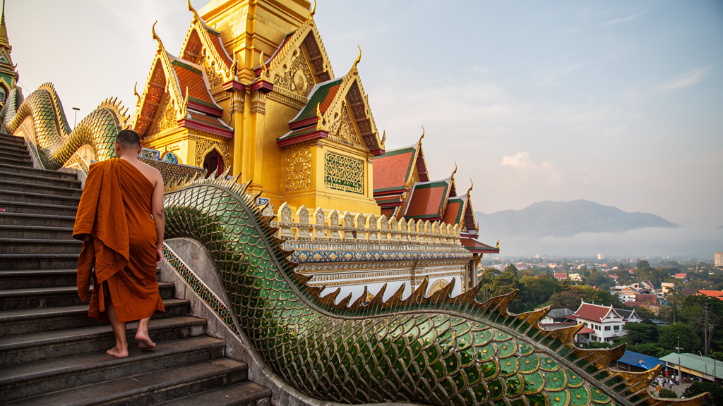 Golden temple on a misty mountain in Chiang Mai at sunrise
